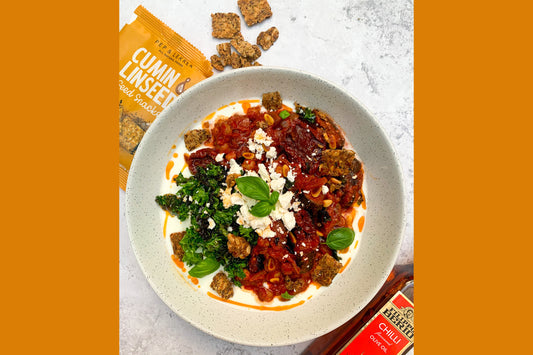 Aubergine and chickpea stew topped with cumin seed snacks